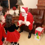 Santa sitting with kids