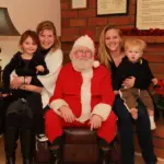 Santa sitting with kids