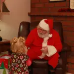 Santa sitting with kids