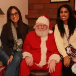 Santa sitting with people