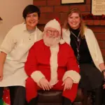 Santa sitting with women