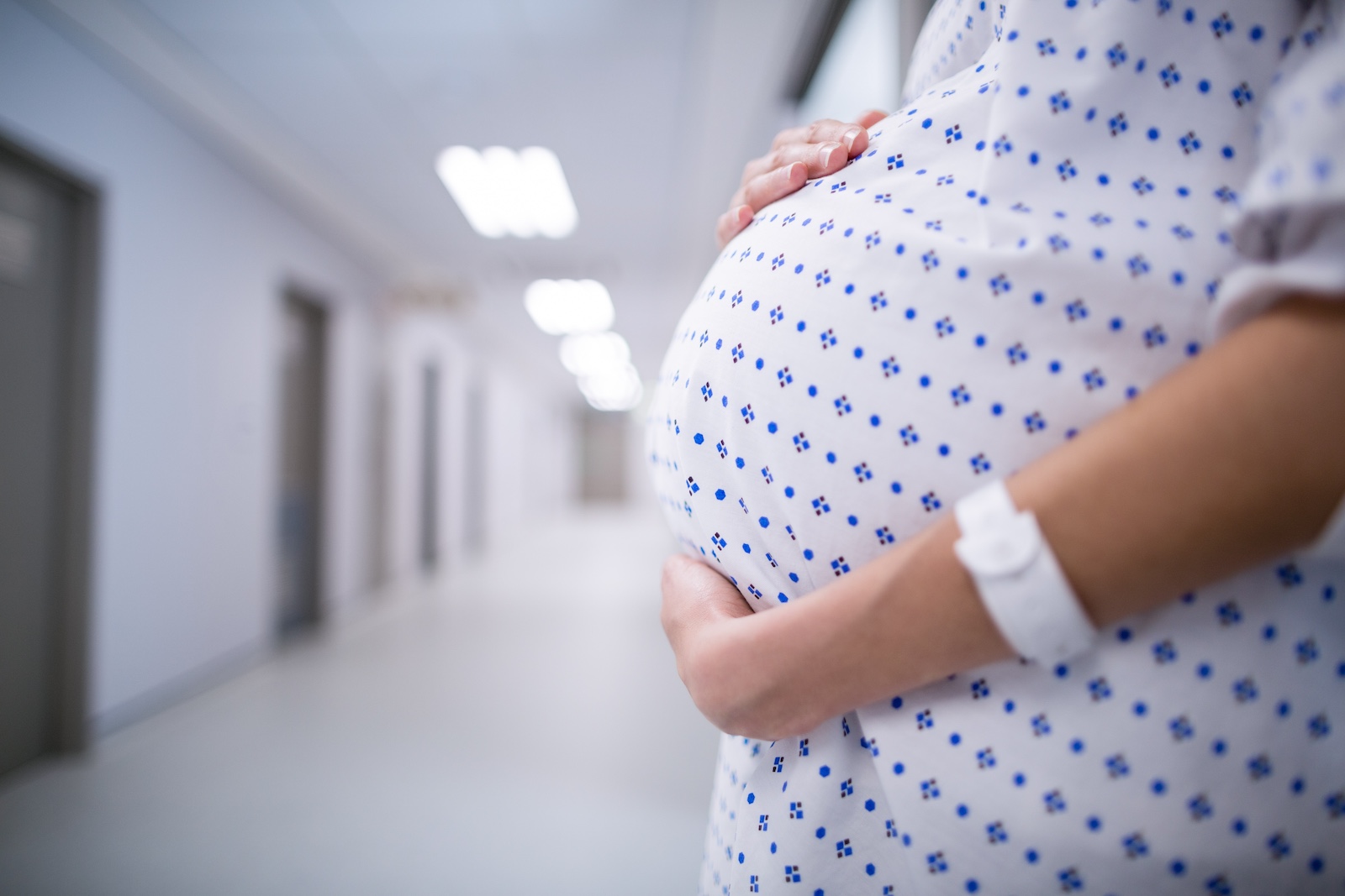 A pregnant woman in a hospital gown