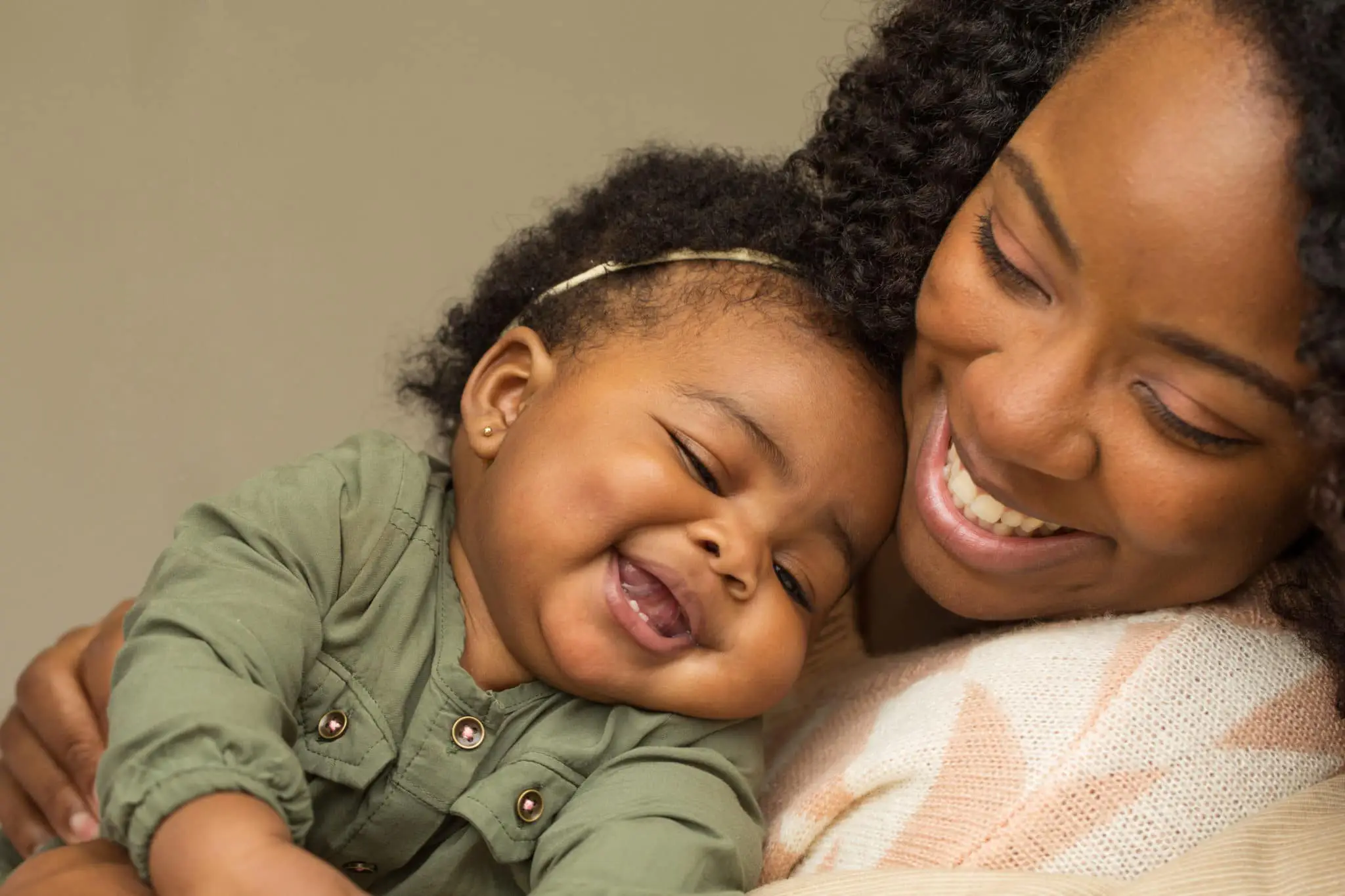 Black mom and baby laughing