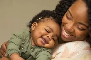 Black mother and child laughing