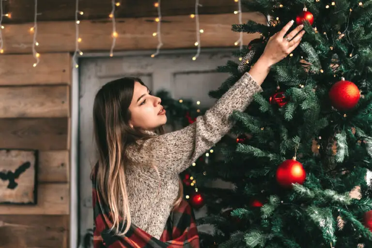 Woman fixing christmas lights