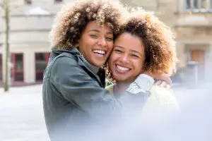 Black sisters hugging