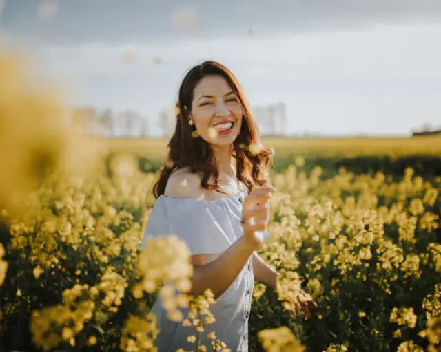 Woman in field with flowers